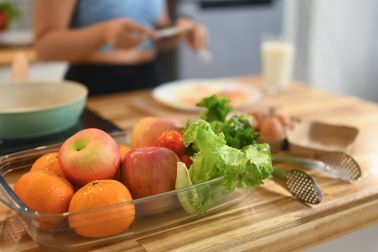 Fruits and vegetables on wooden kitchen counter. Healthy eating concept