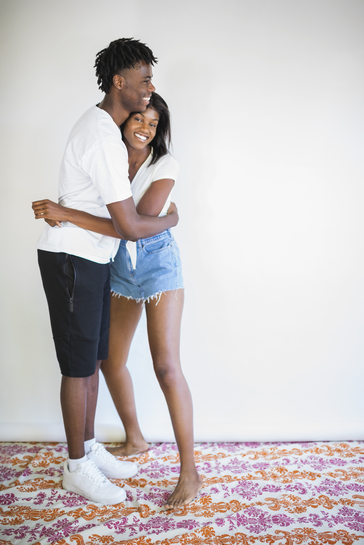 Young hetrosexual couple embracing indoors