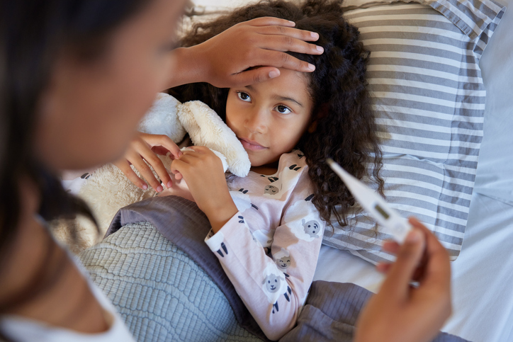 Mother checking daughter temperature