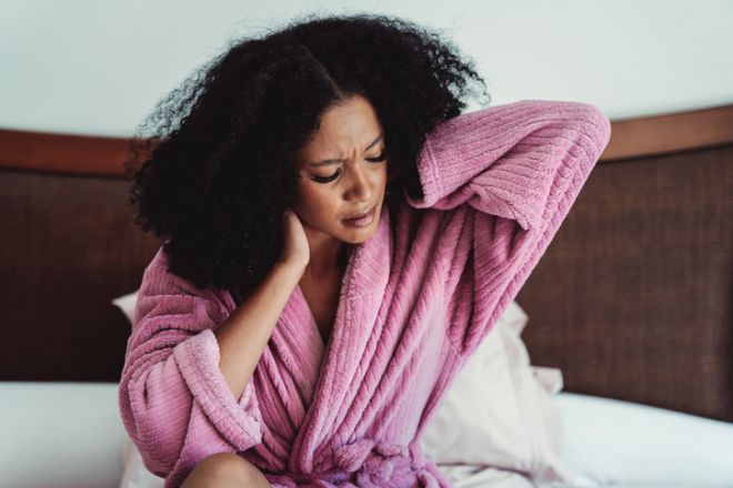 Woman waking up with neck pain