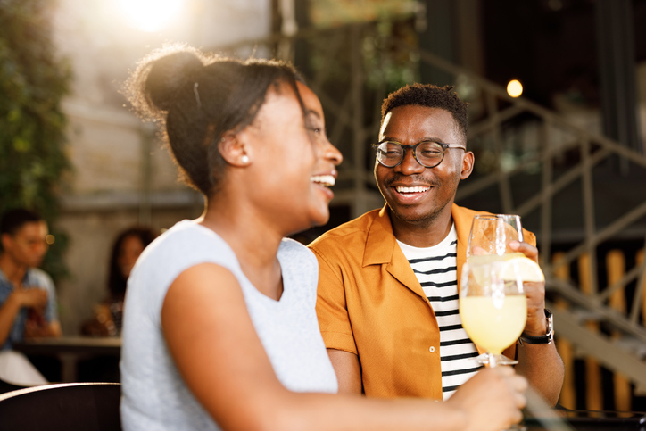 Happy African American couple talking in a café.
