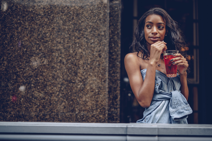Young woman drinking soda
