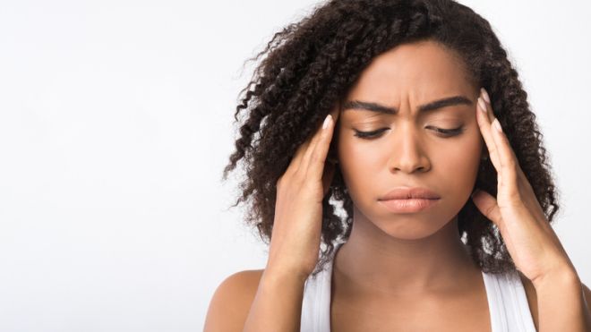 Sad african american girl suffers from strong headache