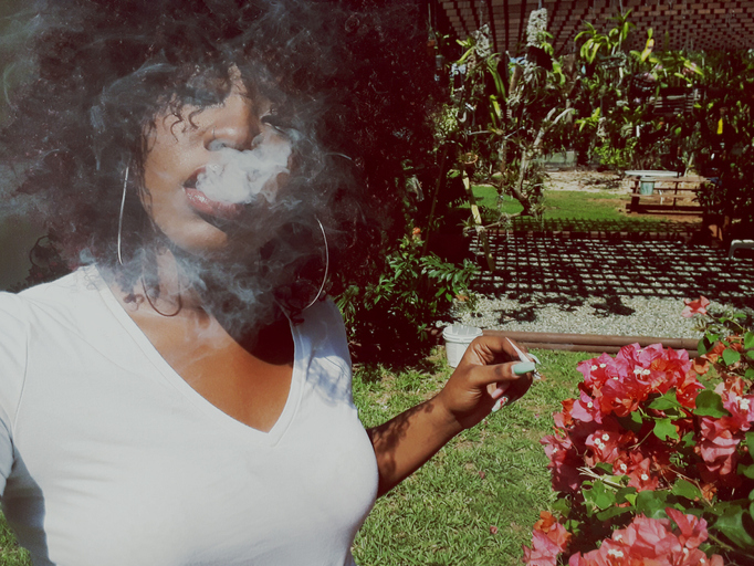 Young Woman Smoking At Park