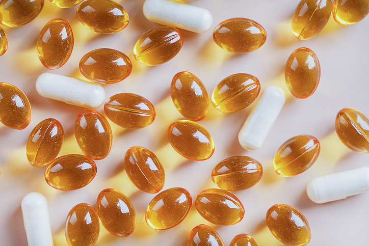 Variety of vitamin pills on beige background, supplemental and healthcare product, Including vitamin D3, zinc. healthy lifestyle concept.