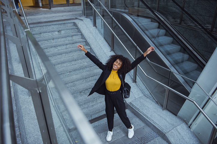 Joyful business woman celebrating outdoors