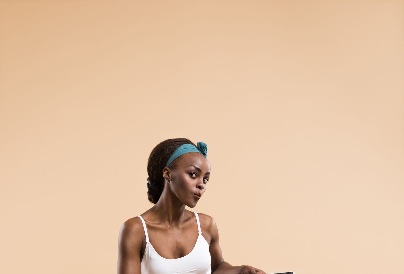 Sexy fit african woman posing with scales