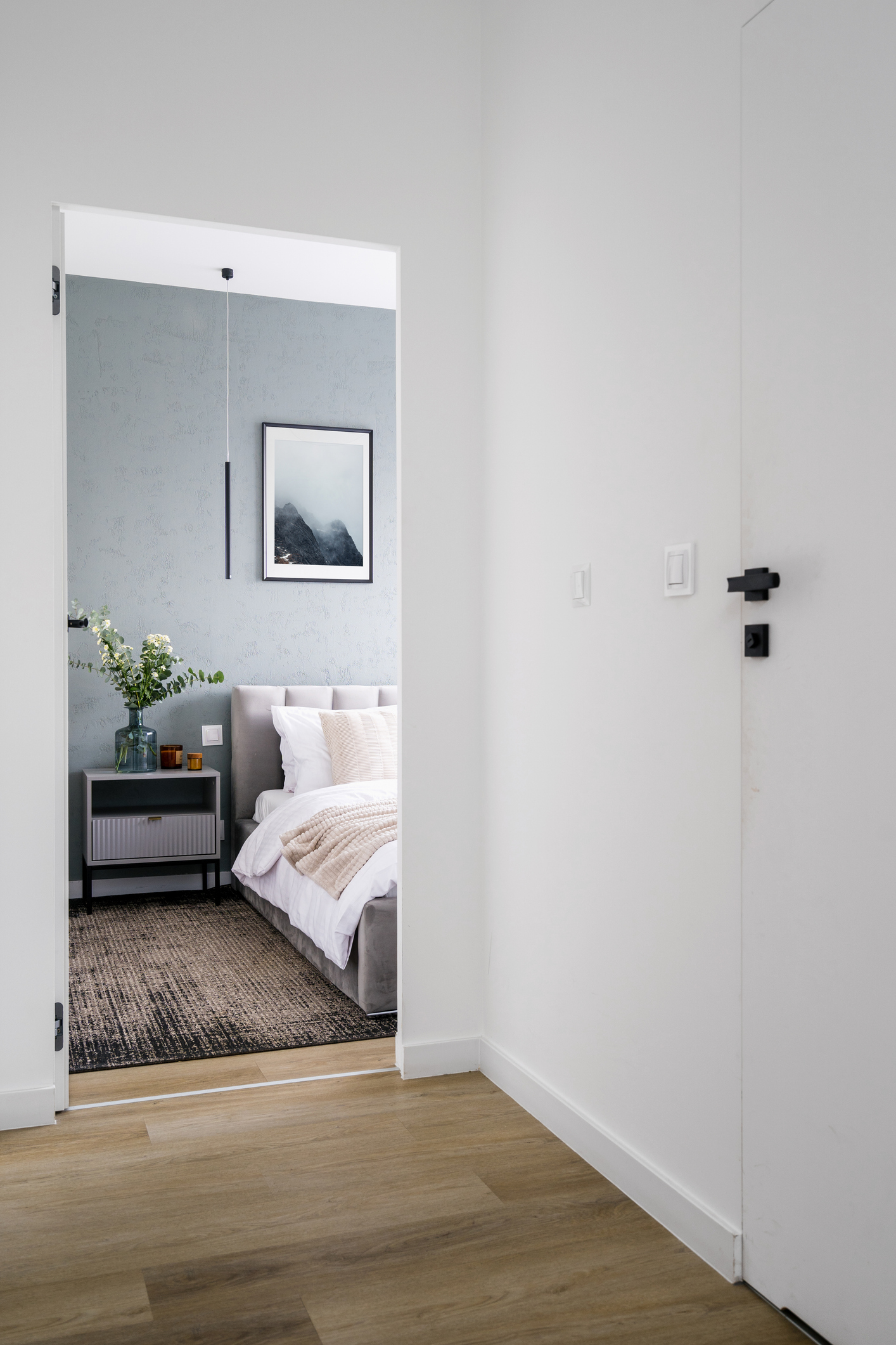 Minimalist interior of white apartment with cozy bedroom