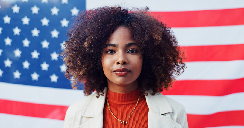 Black woman, portrait and american flag for support, pride and heritage in background. Vote, opinion and patriotism in solidarity, freedom and representation in celebration for human rights