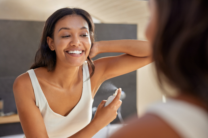 Multiethnic young beauty woman using spray deodorant