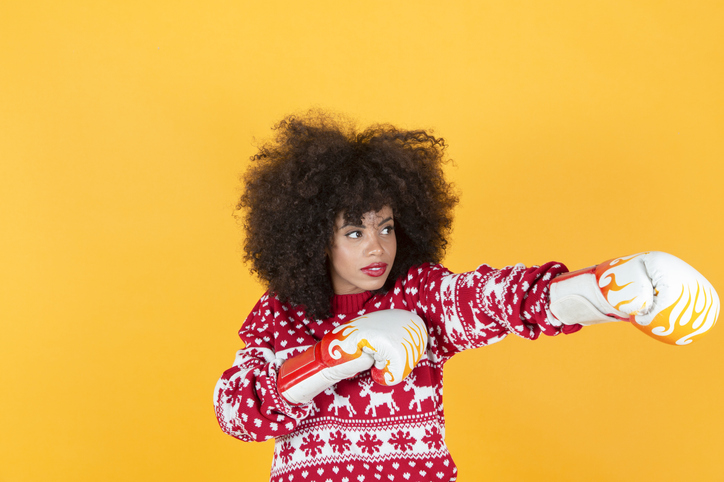 hispanic latina christmas woman boxing, yellow background