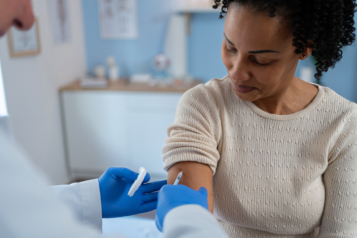 The patient receives the injection with a smile