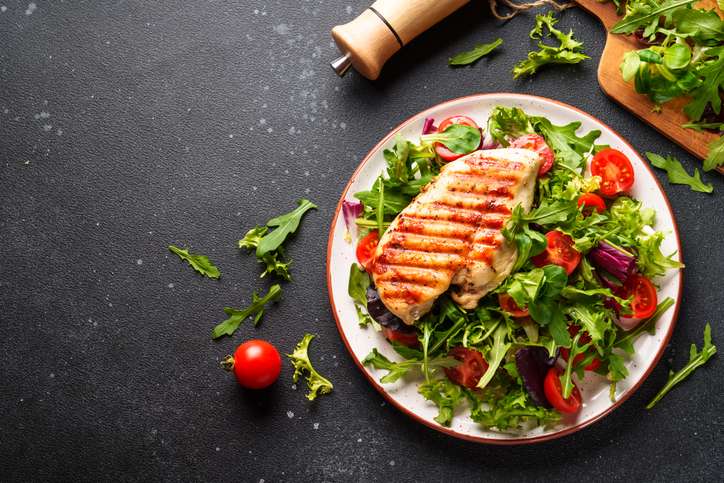 Chicken steak with fresh salad top view.