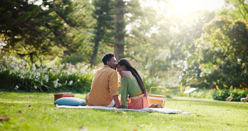 Back, kiss and love with black couple and picnic for bonding, happiness and romantic date. Calm, support and conversation with man and woman at park for commitment, valentines day and summer