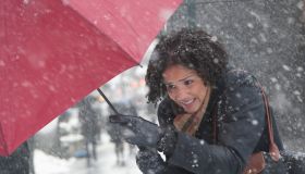 Young woman walking in a snow storm