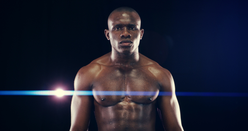 Serious, boxer and portrait of black man in studio for match, challenge or competition training. Shirtless, sports and shirtless African male athlete with muscles for workout by black background.
