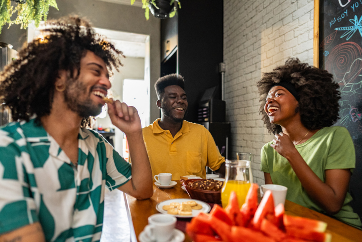 Friends talking while having breakfast at a hostel