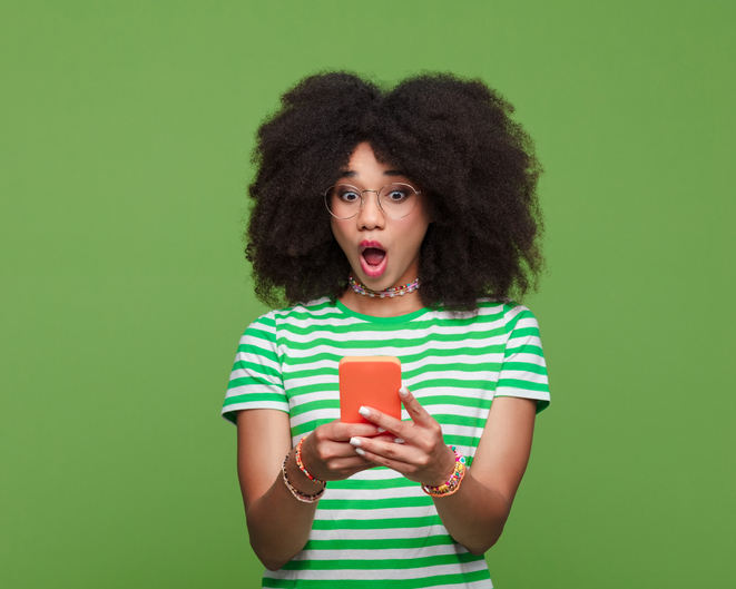 Portrait of surprised gen z girl using smart phone