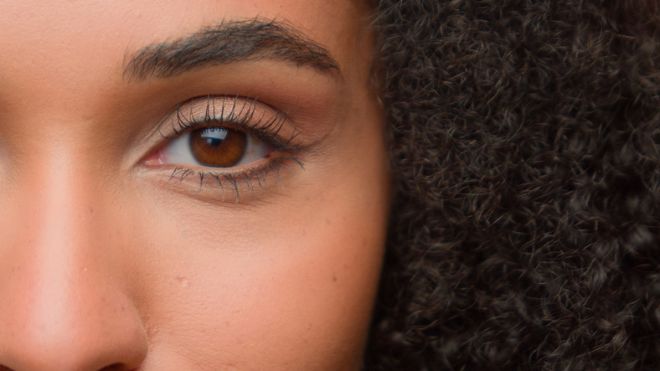 Beauty female portrait half of face close up eye beautiful make-up arrow eyelashes eyeliner eyelid mascara African American woman girl perfect skin natural complexion skincare cosmetics moisturizing