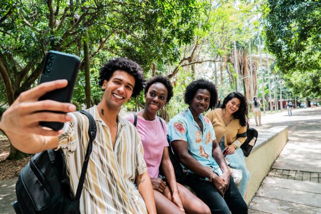 Students taking selfie in a public park