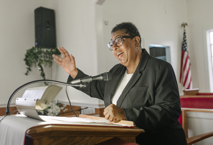 Passionate Preacher Delivering Sermon in Church