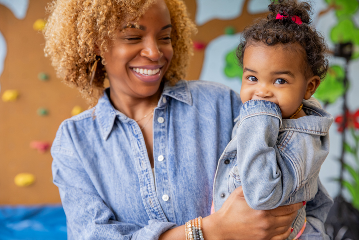 Mother drops her toddler daughter off at daycare