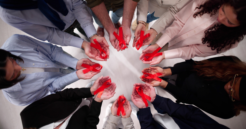 Supporting HIV AIDS patients through charity with red awareness ribbon