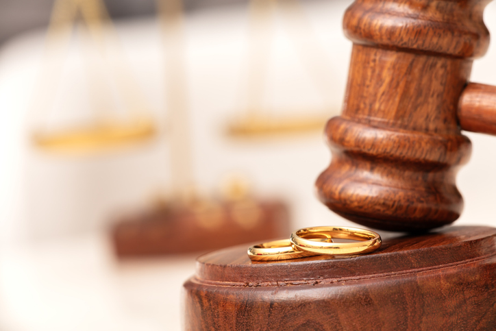 Law theme. Judge gavel wedding rings on Marble background. Divorce proceedings