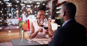 Portrait Of Romantic Couple Toasting Red Wine