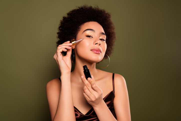 Photo of beautiful gorgeous lady apply liquid serum isolated on khaki color background