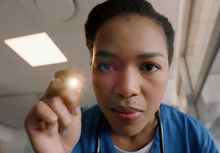 Woman, portrait and doctor with flashlight for healthcare, exam or diagnosis at hospital. Face of female person or nurse checking patient eyes in test for pupil, iris or optic nerve defect at clinic