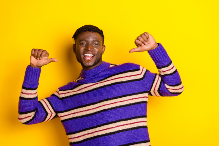 Photo of nice young man point fingers self wear pullover isolated on yellow color background