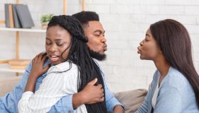 Unfaithful Black Boyfriend Kissing Another Girl While Hugging His Girlfriend