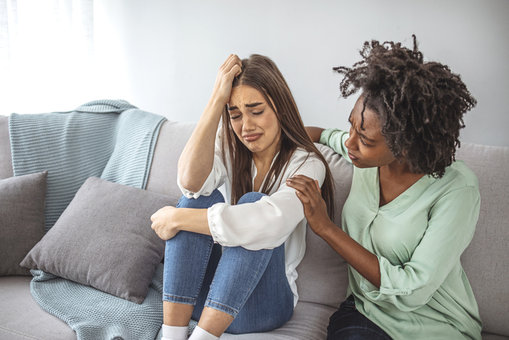 Friend trying to calm down her friend.