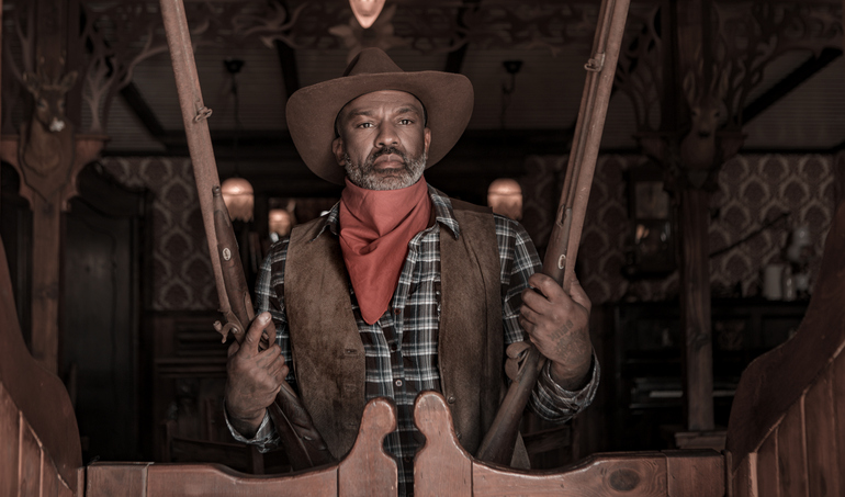 Handsome Black Cowboy in an authentic wild west setting