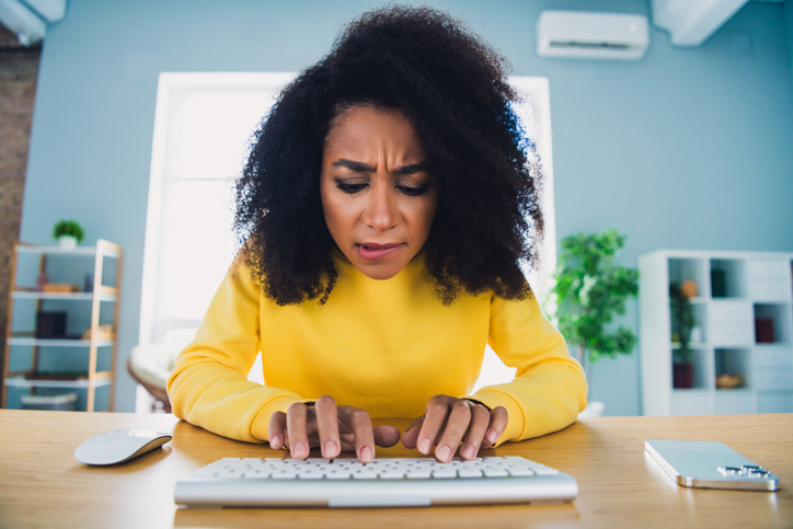 Photo of worried charming woman sitting table hacking website touching gadget keypad workspace