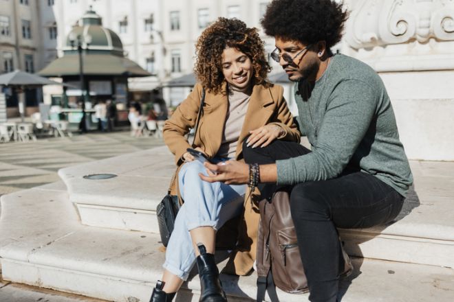 Couple Enjoying Break on Steps in City
