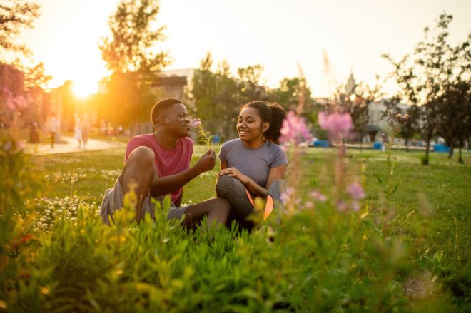Young couple in a park in summer sunset