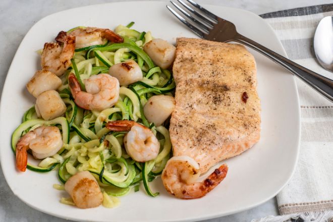 baked salmon with zucchini noodles, shrimp and scallops