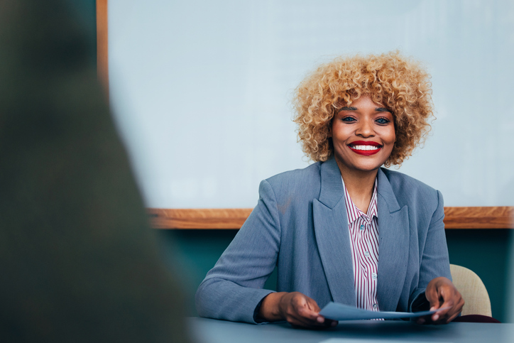Professional Businesswoman Smiling Confidently During a Meeting in a Modern Office