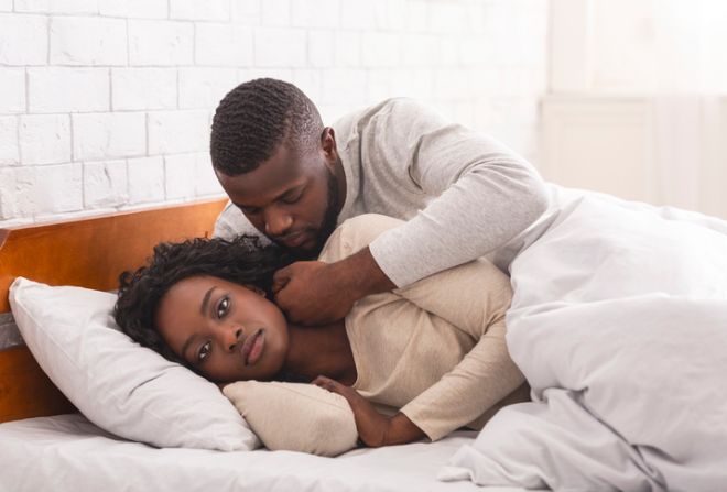 Black woman ignoring husband in bed, refusing to make love