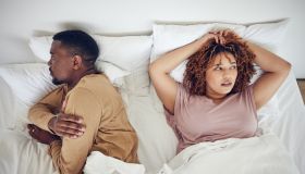 Couple fight, angry and bedroom with a black woman and man feeling frustrated in a bed. Home, conflict and relationship problem from above of a marriage fail and divorce issue in the morning