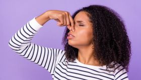 Profile side photo of unhappy woman wavy hair cover nose feel bad smell stink isolated on violet color background