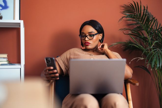 Professional Woman Working Remotely With a Laptop in a Modern Office