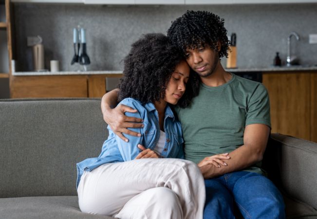 Man consoling his girlfriend while she is having a mental breakdown at home