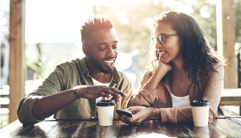 Coffee, smile and couple with smartphone in cafe for internet connection, social media and online post. Happy, man and woman with technology in restaurant for love, digital communication and bonding