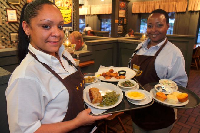 Waitresses serving food at Cracker Barrel Old Country Store restaurant.