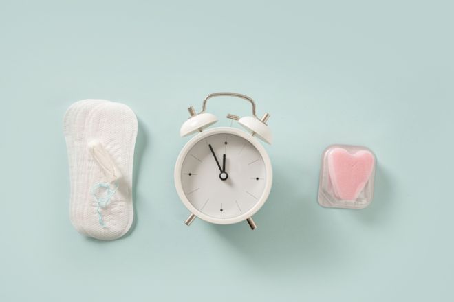 Female different tampons, daily pads, clock. Limited time use concept.