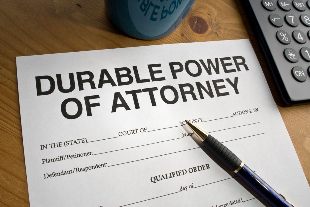 Durable power of Attorney paperwork on wooden desk with pen