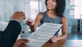 Business people signing a contract in the office.